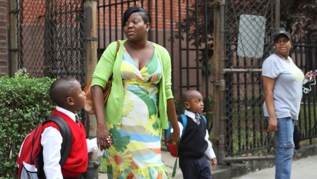 Suzette Williams walks her sons Kyle and Kahlil towards the school.
